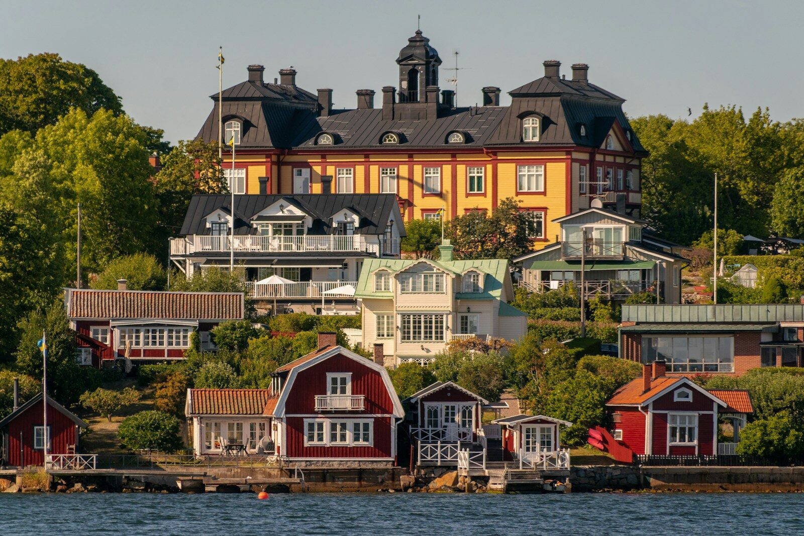 a group of houses next to a body of water